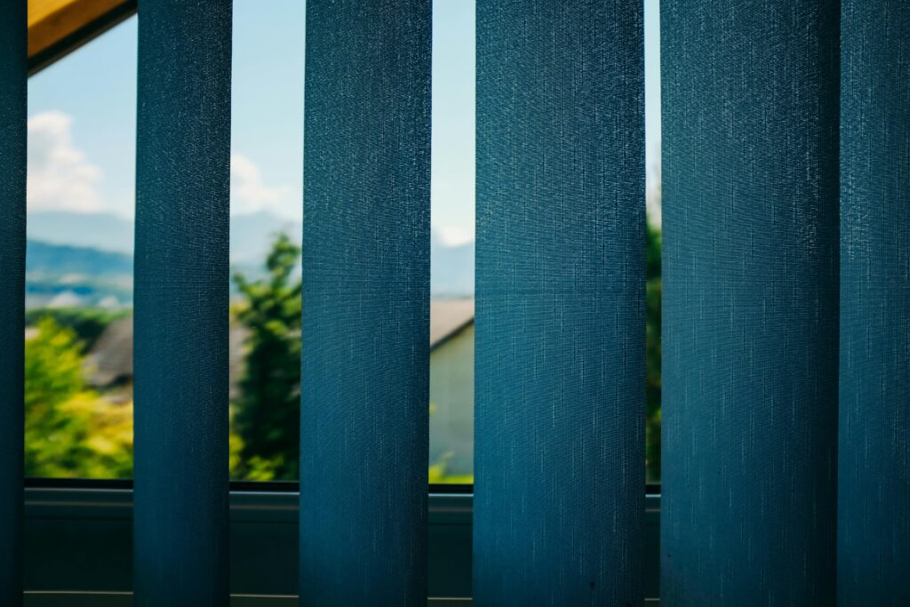 pexels photo 4534512 4534512 Through blue blinds view on green trees growing in yard of home located in suburb